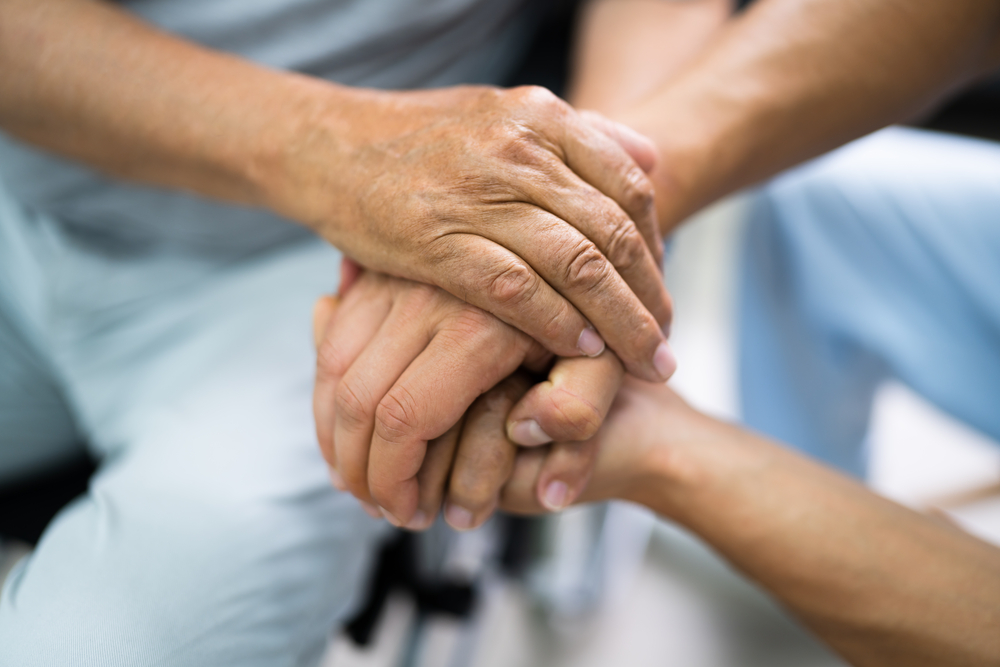 Nursing Home Abuse - Elder Patient Helping Nurse Hand